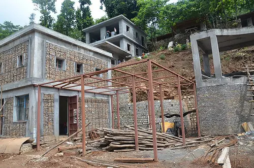 Gabion stone walls and steel framing under construction on the Atali Ganga hillside