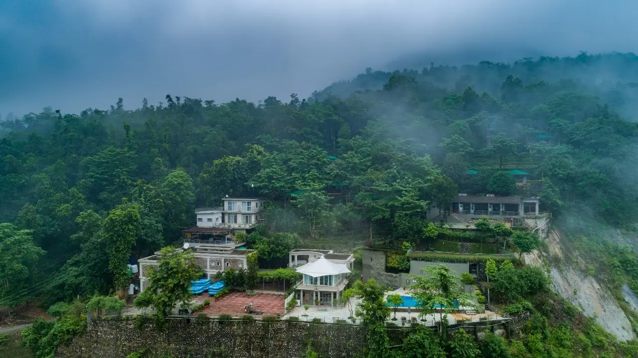 Aerial view of Atali Ganga cottages arranged across the hillside
